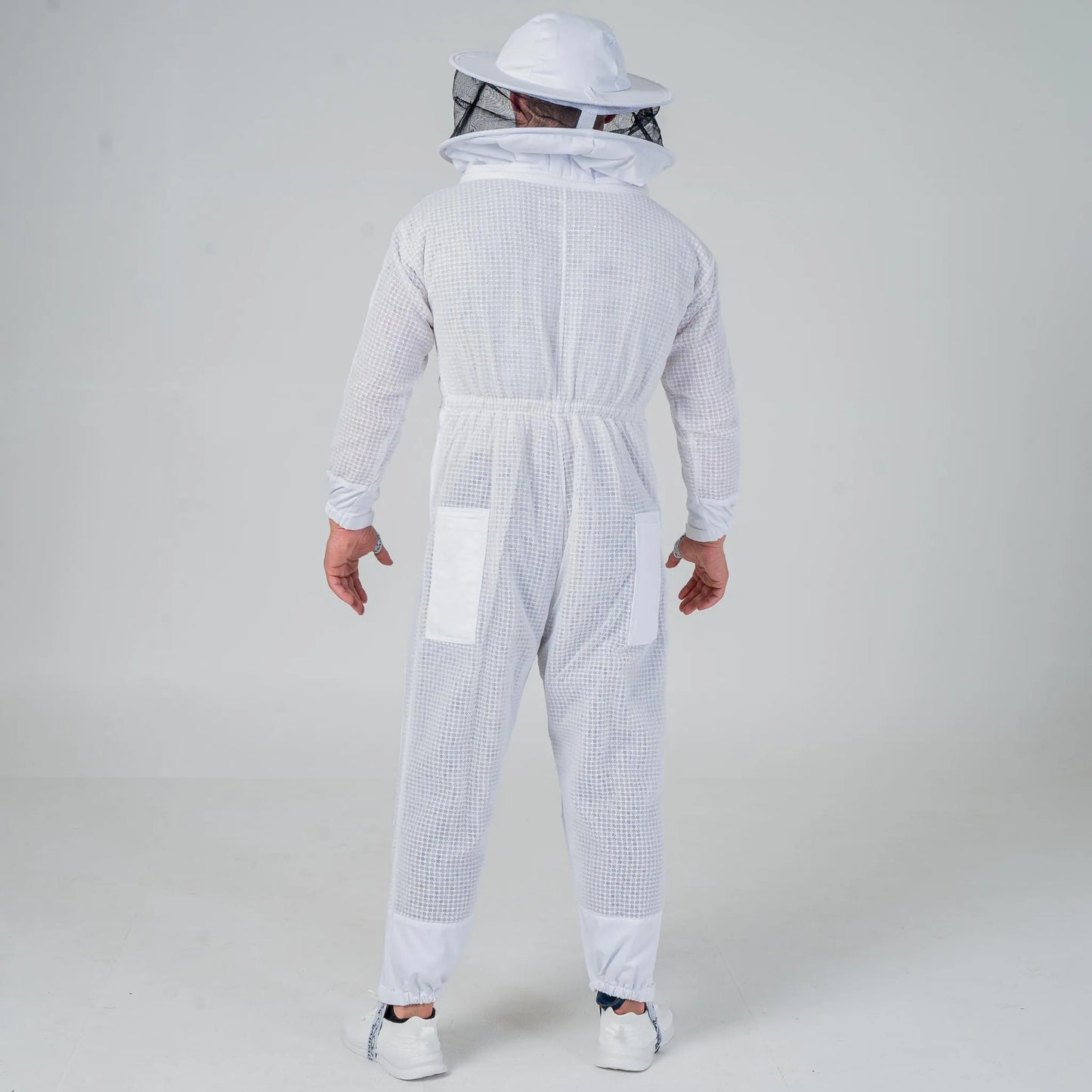 Man wearing OZ Armour white 3 layer beekeeping suit with round hat veil, full length back view
