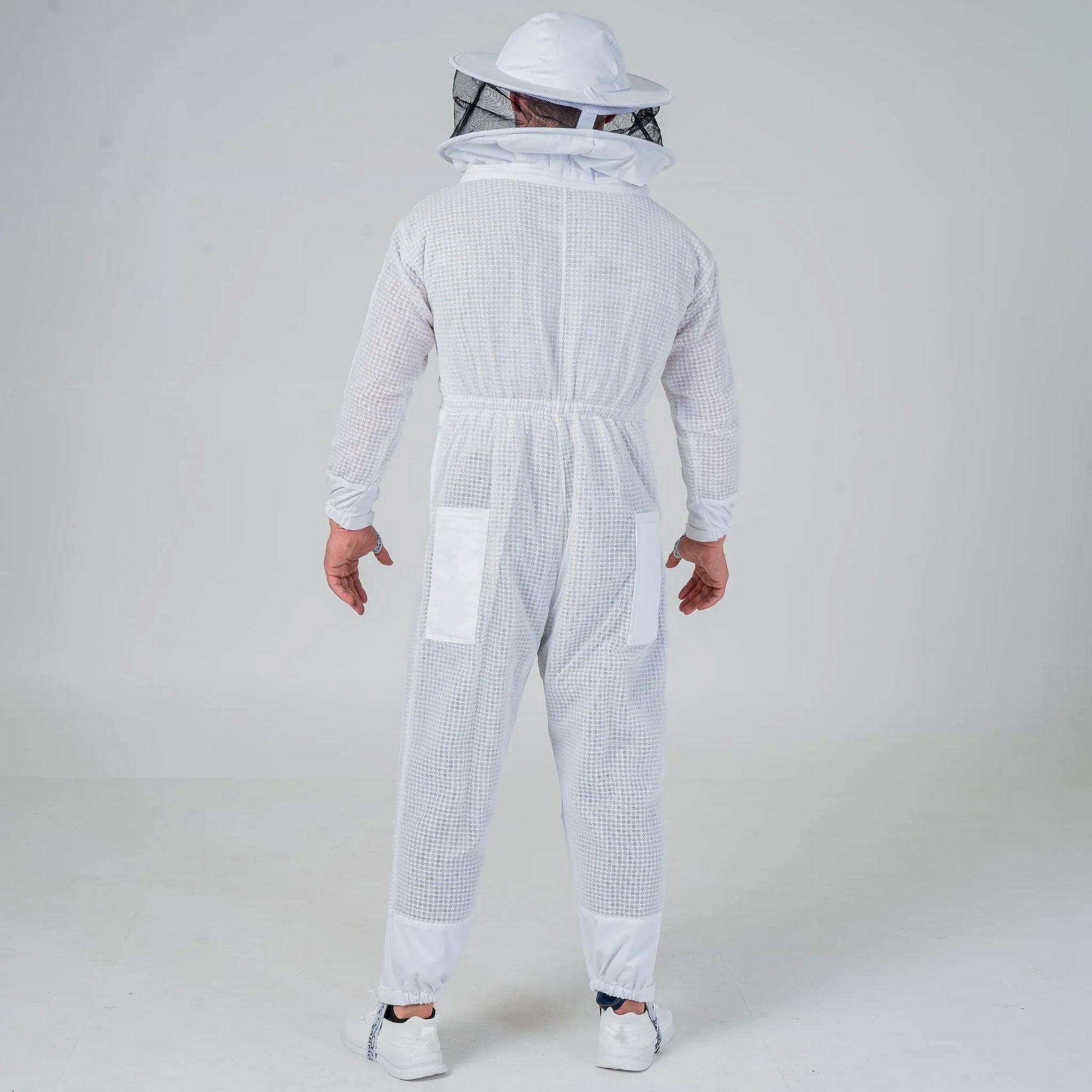Man wearing OZ Armour white 3 layer beekeeping suit with round hat veil, full length back view