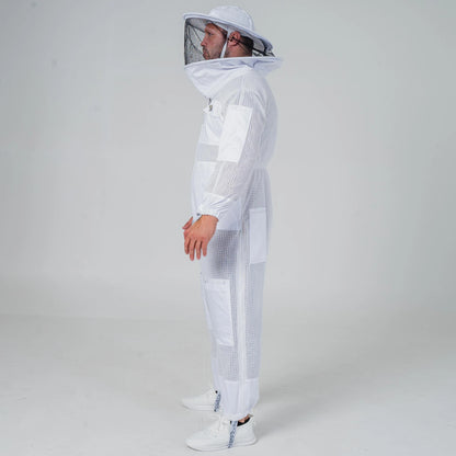 Man wearing OZ Armour white 3 layer beekeeping suit with round hat veil, full length side view