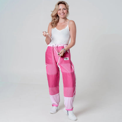 Woman wearing pink beekeeping trousers holding the waist drawstring, front view
