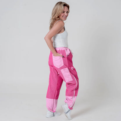 Woman wearing pink beekeeping trousers, side view full body