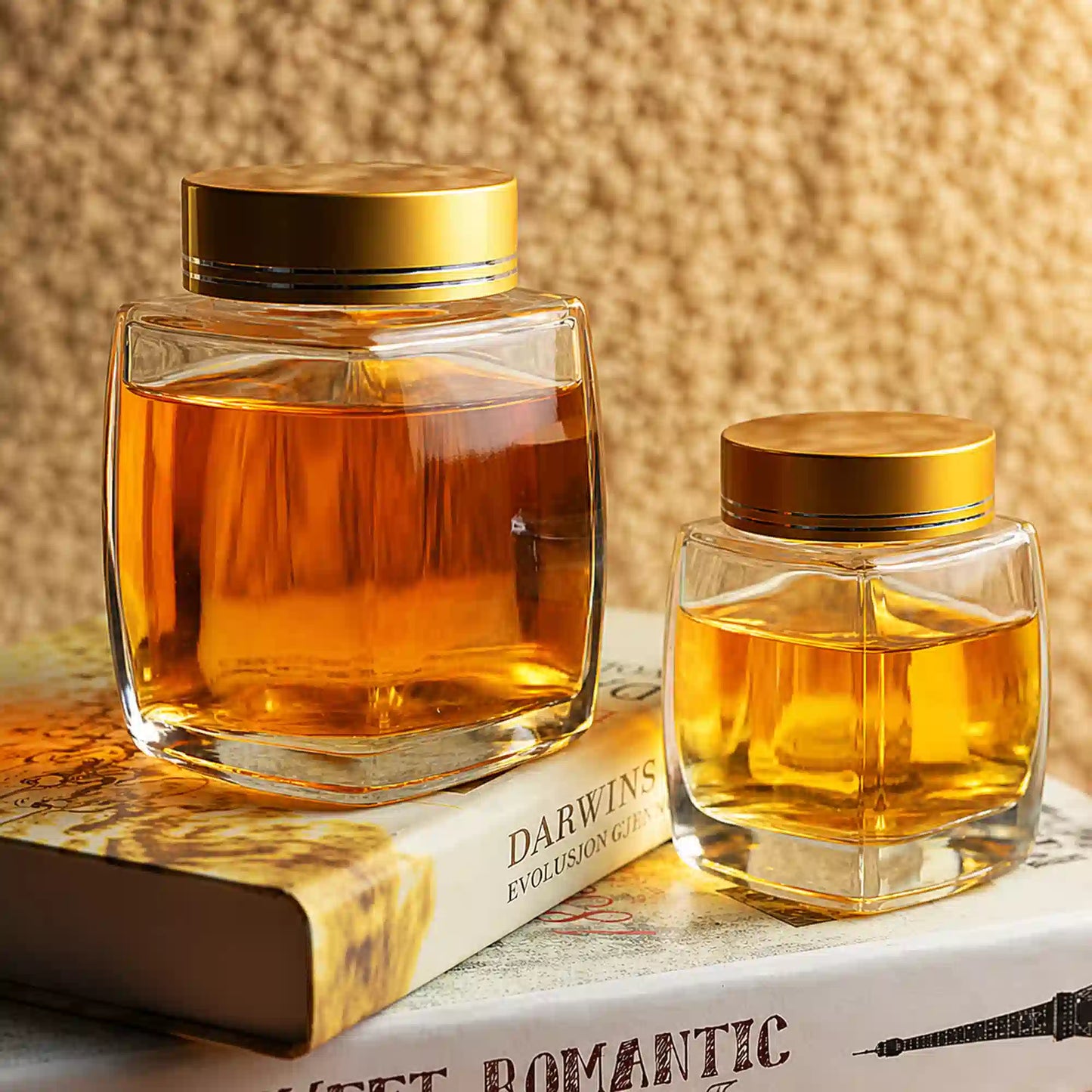 Elegant square glass jars with gold caps for honey and decor