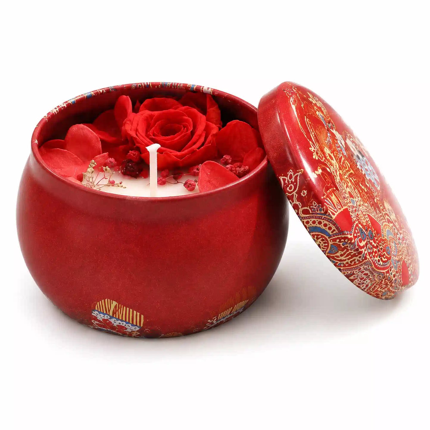 A red ceramic candle jar with a matching lid, featuring a red rose and red flower petals on the wax inside, set against a plain white background.