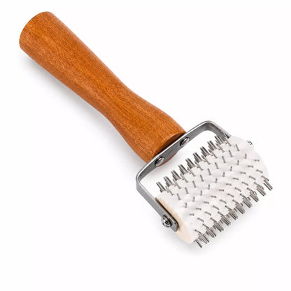 Angled view of stainless steel honey uncapping roller tool
