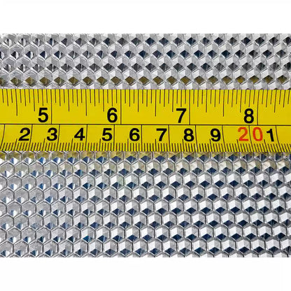Close-up of wax foundation sheet pattern with measuring tape on machine