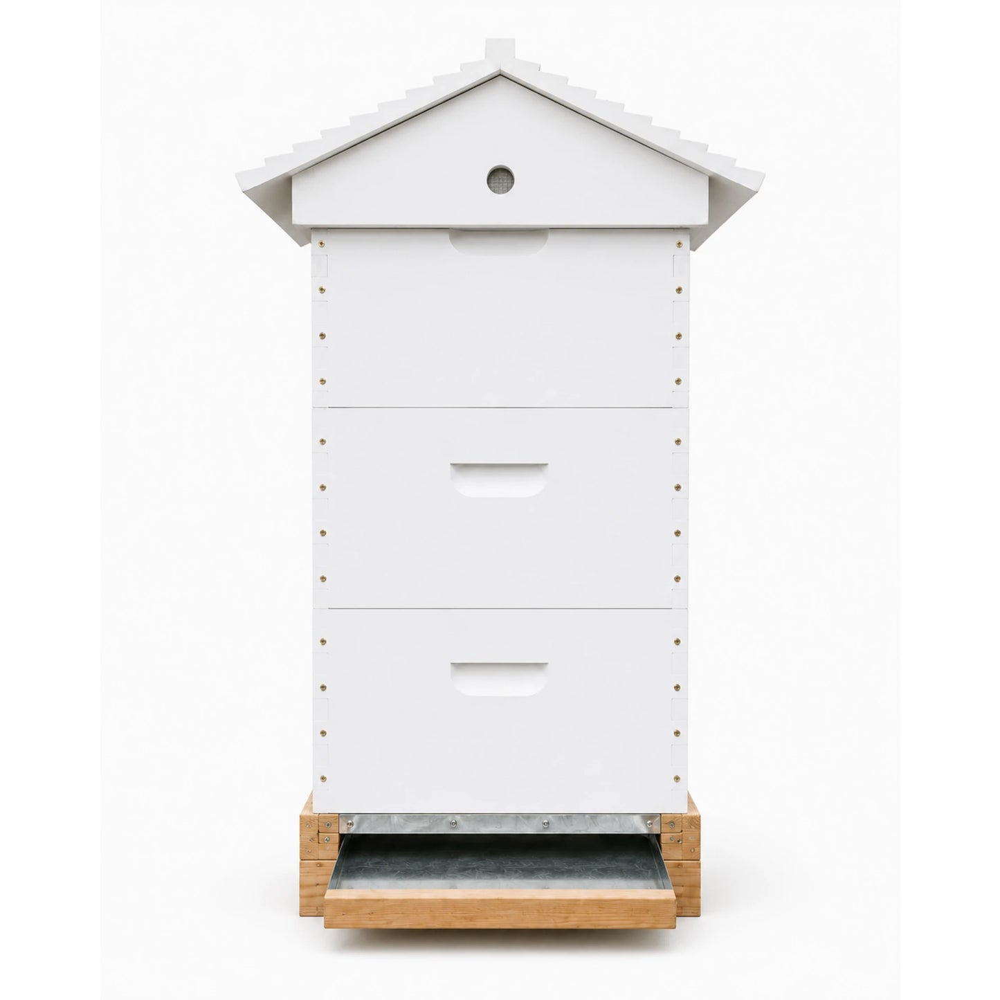 Side profile of a white three-box Langstroth beehive showing the sloped roof and metal pull-out bottom board on a wooden hive stand